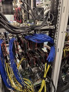 Rack of GPUs wired up in a deep-learning compute cluster